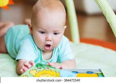 Adorable Baby Looking A Book 