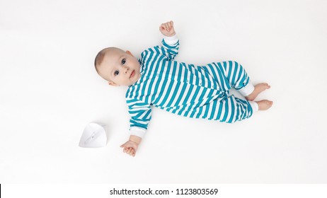 Adorable baby and paper boat - Powered by Shutterstock