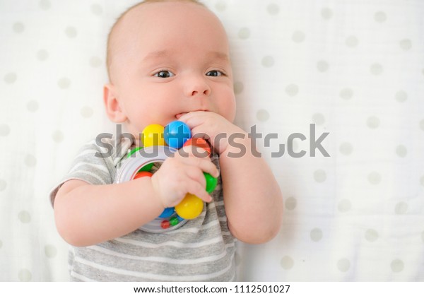 baby holding rattle