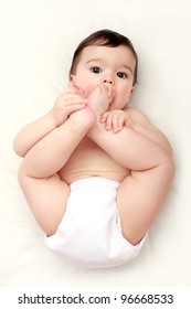 Adorable baby sucking his toes