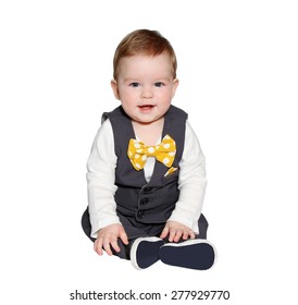 Adorable Baby Wearing Classic Vest And Colorful Bowtie Looking At Camera On White Background