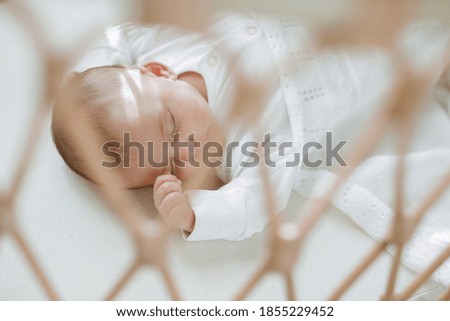 Similar – Newborn baby girl sleeping on blue sheets at home