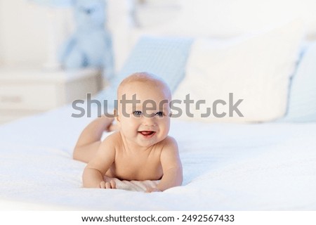 Similar – Image, Stock Photo Happy adorable baby boy is lying on blanket on the grass in the park on summer day. Child in trendy and cute clothes