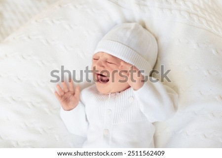 Similar – Image, Stock Photo Baby lies on a blanket and covers his eyes with his hands