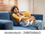 Adorable Beagle dog puppy sleeping on young female owner