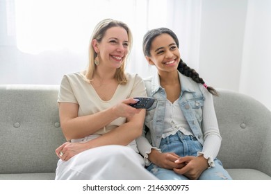 Adorable Black Twin Teen Girl With Mother On Studio White Background Holding Remote Control