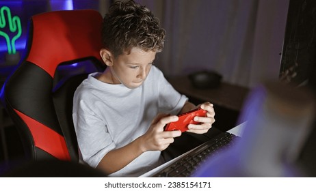 Adorable blond boy streamer, engrossed in serious game playing, live streaming his smartphone game from a cozy gaming room - Powered by Shutterstock