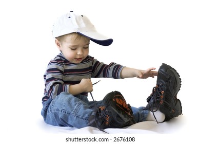 Adorable Boy In Big Shoes Tying Up Shoelaces