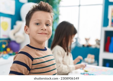 Adorable boy and girl smiling confident sitting on table at kindergarten - Powered by Shutterstock