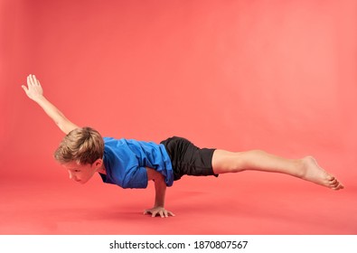 Adorable Boy Gymnast Doing One Arm Handstand Exercise