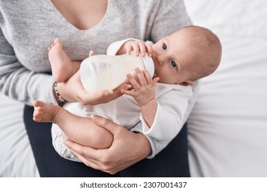 Adorable caucasian baby sucking feeding bottle at bedroom - Powered by Shutterstock