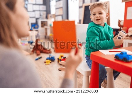 Adorable caucasian boy having vocabulary lesson at kindergarten