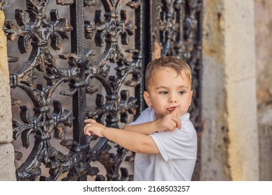 Adorable caucasian kid asking to be quiet with finger on lips. silence and secret concept