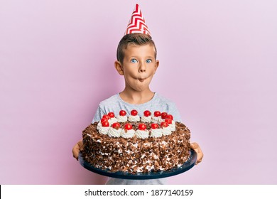 Adorable Caucasian Kid Celebrating Birthday With Cake Making Fish Face With Mouth And Squinting Eyes, Crazy And Comical. 