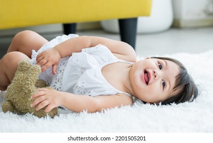 Adorable Caucasian Little Baby Daughter Girl, Laughing, Smiling With Happiness, Good Health, Relax Day Sleeping And Laying Down Alone With Lullaby, Hugging Bear Doll On White Bed At Home. Kid Concept