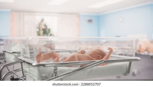 Adorable Caucasian Newborn Child Lying in Hospital Bed in a Nursery Clinic. Little Playful and Healthy Baby. Medical Health Care, Maternity and Parenthood Concept