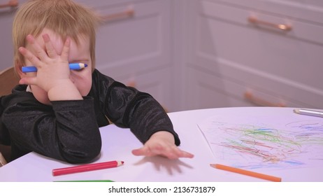 Adorable Caucasian Toddler Baby Girl Drawing Abstract Shapes Picture With Pencil Crayons Making Funny Faces