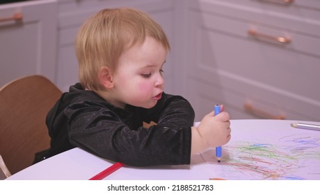 Adorable Caucasian Toddler Baby Girl Drawing Abstract Shapes Picture With Pencil Crayons Making Funny Faces