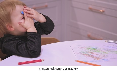 Adorable Caucasian Toddler Baby Girl Drawing Abstract Shapes Picture With Pencil Crayons Making Funny Faces