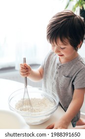 Adorable Cheerful Boy, Toddler Kneads Dough In The Kitchen. Children Cat Dough At Home. Real Life Moments