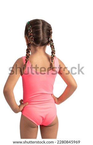 adorable child from the back wearing a pink bathing suit with braids in her hair