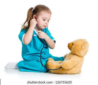 Adorable Child With Clothes Of Doctor Playing And Examining Plush Toy