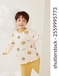 Adorable Child in Cute Bear Print Pajamas Smiling Brightly - Cozy and Playful Kidswear for Comfort and Style.