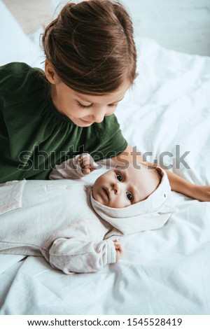 Image, Stock Photo Mother hugging her baby in front of fireplace