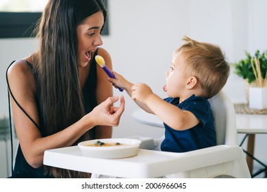 An Adorable Child Offering Food To His Mother