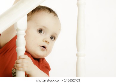 Adorable Child Peeps Over The Stair Bannister