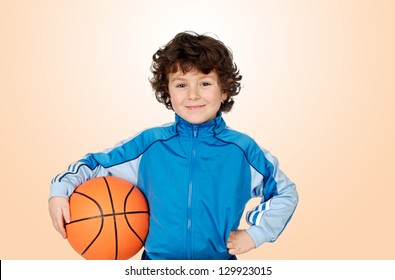 Adorable child playing the basketball with a orange background
