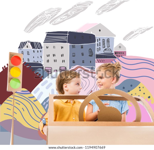 adorable children driving cardboard car with traffic\
lights in drawn city