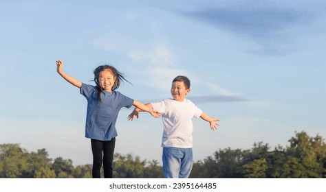 Adorable children having fun outdoor. Stretching exercises of little girl and boy outdoor, children playing outdoors. Asian kids playing - Powered by Shutterstock