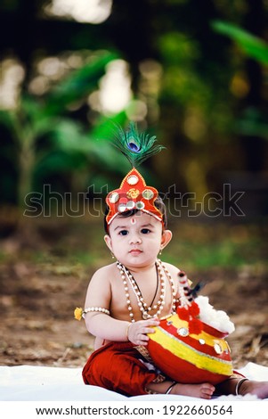 Adorable crawling baby wearing Krishna costume. India 04-feb-2020