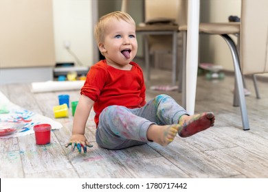 Adorable Cute Caucasian Little Blond Naughty Toddler Boy Enjoy Having Fun Painting With Brush And Palm At Home Indoors . Cheerful Happy Kid Smiling Drawing Masterpiece Art Picture. Messy Dirty Room