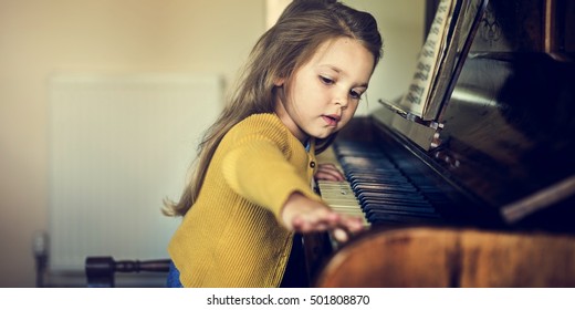 Adorable Cute Girl Playing Piano Concept - Powered by Shutterstock