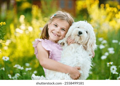 Adorable cute little girl and her puppy on the nature in the summer. Happy school child with eyeglasses holding Maltese dog, having fun with playing. Bright sunset light, active kid. - Powered by Shutterstock