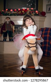 Adorable, Cute, Little Girl Sitting On Her Pony Toy