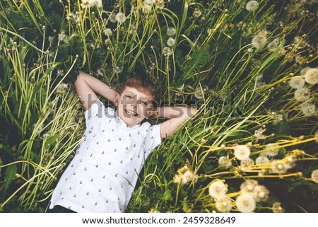 Similar – Image, Stock Photo Funny kid blowing on pinwheel