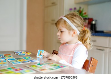 Adorable Cute Toddler Girl Playing Picture Card Game. Happy Healthy Child Training Memory, Thinking. Creative Indoors Leisure And Education Of Kid During Pandemic Coronavirus Covid Quarantine Disease