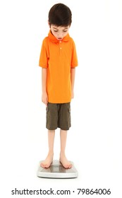 Adorable eight year old boy on scale very thin anorexia nervosa childhood onset concept.