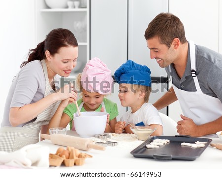Adorable family baking together in the kitchen to make delicious cookies