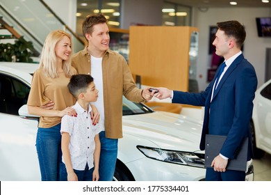 Adorable Family Get Keys By Car In Dealership, Affable Confident Consultant Give Long-awaited Keys To Clients