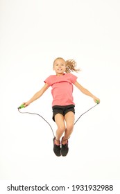 Adorable Female Child With Skipping Rope Jumping In Studio