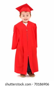 Adorable Four Year Old Boy In Red Graduation Cap And Gown Smiling Over White Background.