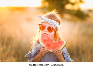 Adorable Girl Eating A Watermelon Outside In The Summer