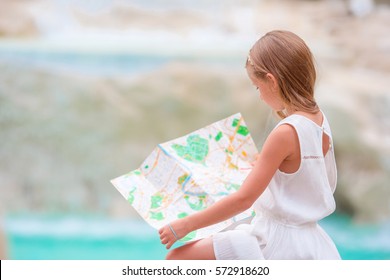 Adorable Girl Looking At Touristic Map Near Trevi Fountain, Rome. Happy Toodler Kid Enjoy Italian Vacation In Europe.