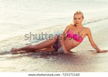 adorable girl lying on sandy beach
