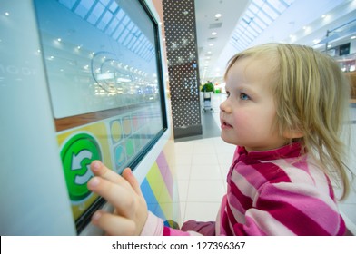 Adorable Girl Play Computer Game With Touchscreen In Supermarket