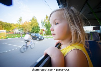 Adorable Girl Ride By Bus And Look Through Open Window Outside